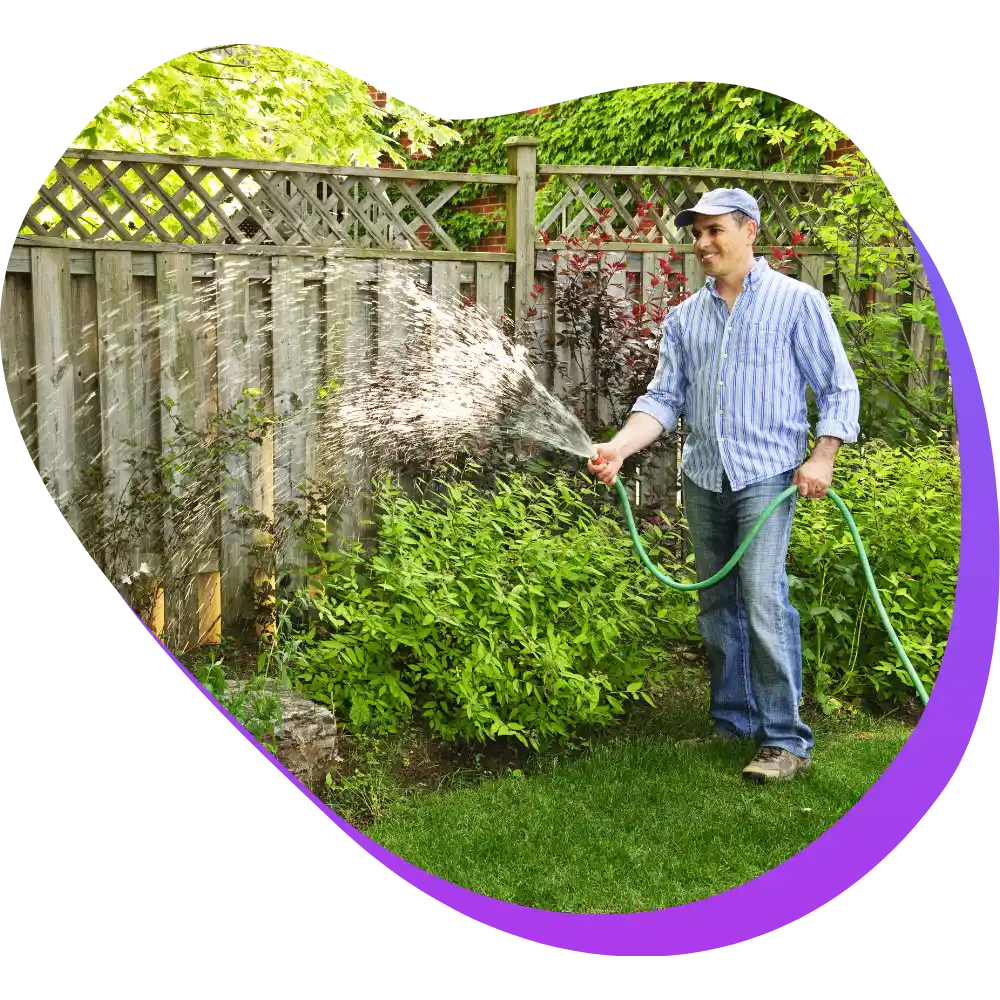 Support worker watering garden