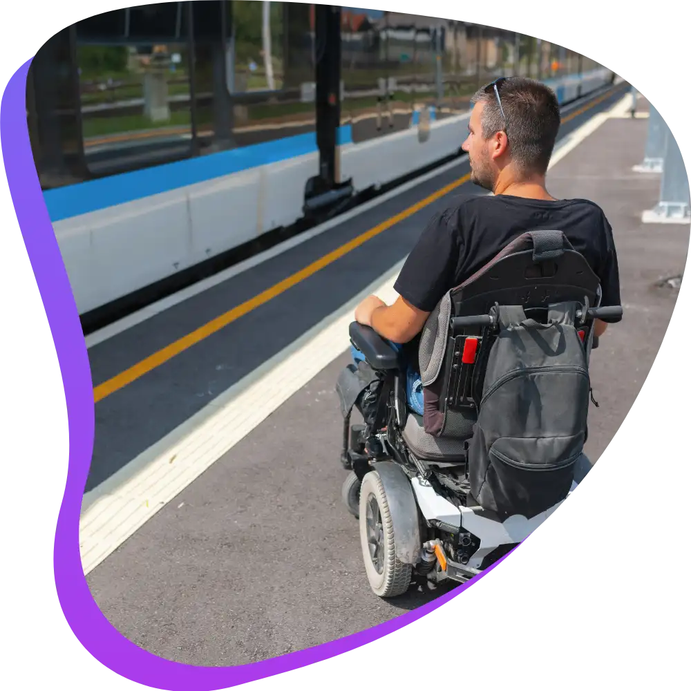 Disabled man in wheelchair at train station