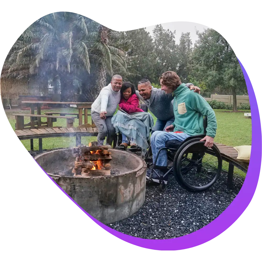 Diverse friends sitting around fire