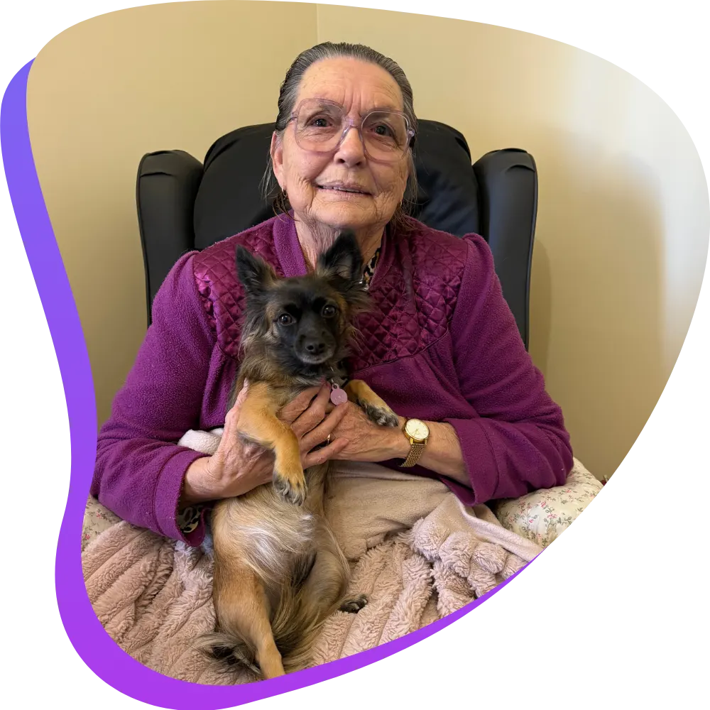 Elderly woman sitting in chair with dog