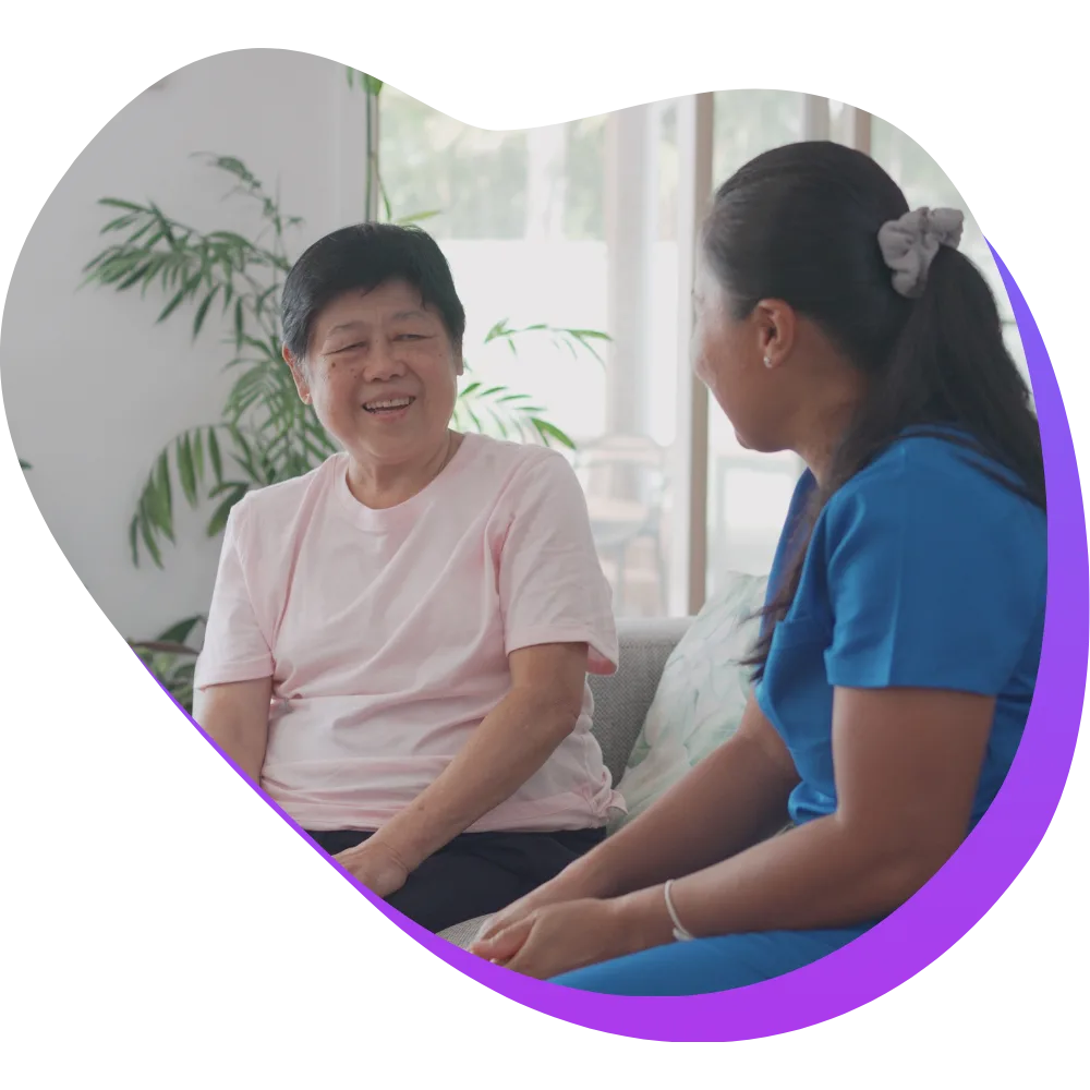 Nurse sitting with elderly patient